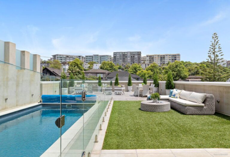 Modern rooftop pool and lounge area in Auckland, cleaned and updated with new fake grass turf