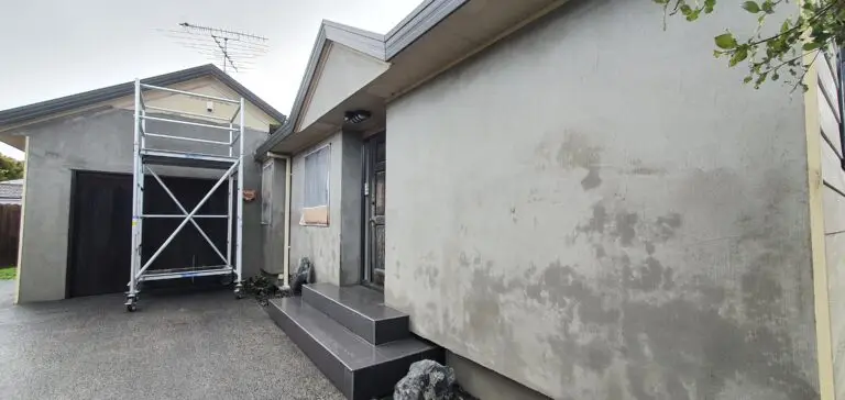 The front of a house which is currently moldy, decaying, and was resurfaced by Market Ready, adding value to the look of the property.