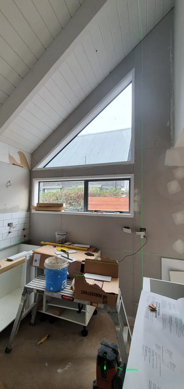 A small kitchen nook in the process of being tiled. With these tiling services, the kitchen is turned into a clean and welcoming kitchen.