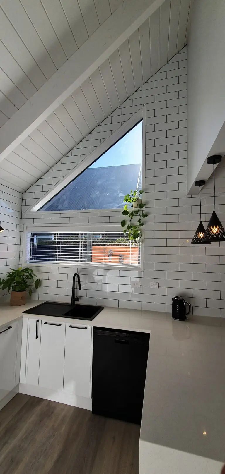 The new kitchen tiling, cleanly done with a consideration for space.