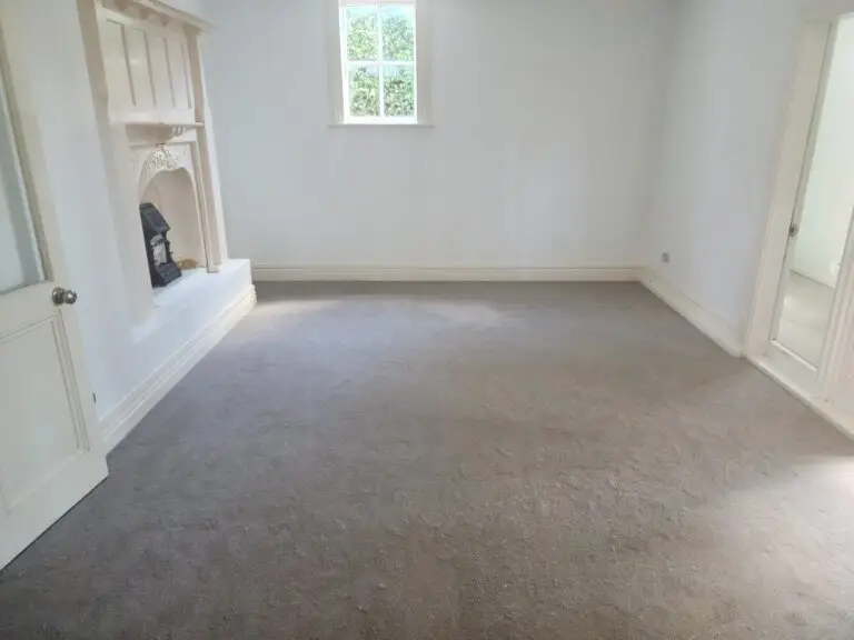 The result of carpeting services with a clean job putting carpet into the room.