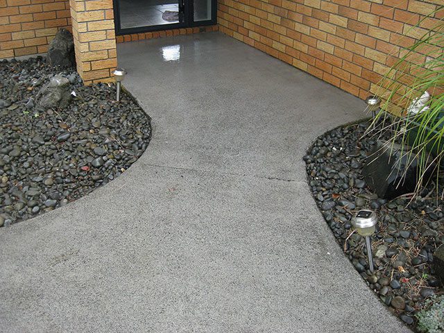 Concrete pressure washing services that improved entrance concrete appearance.