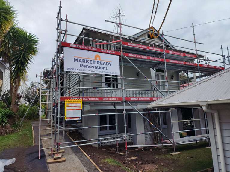 Scaffolding surrounding a house during renovation. Market Ready Renovations project with Roman Scaffolding for home improvement.