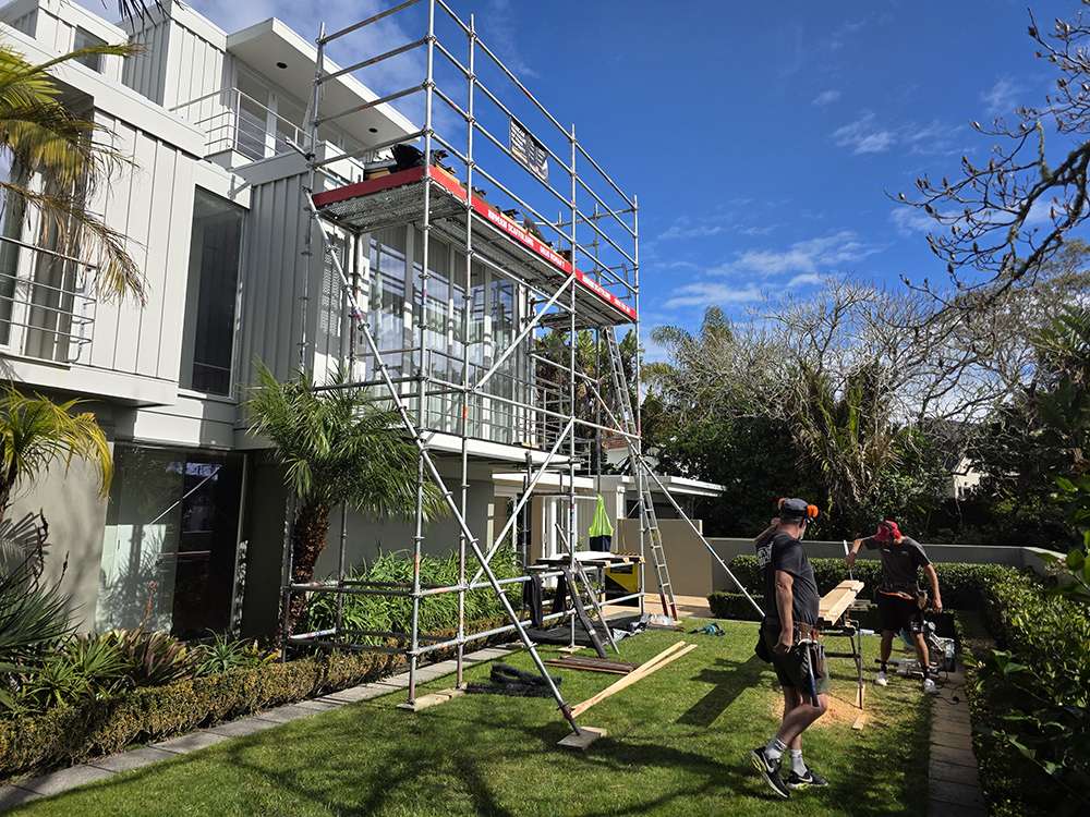 Scaffolding system erected on-site for building project. Safe access solution for construction and maintenance work on residential property.