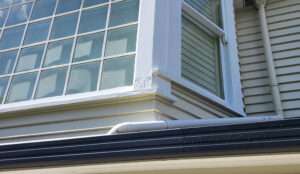 Close-up of a window showing signs of window rot, highlighting damage to the window frame and surrounding structure.