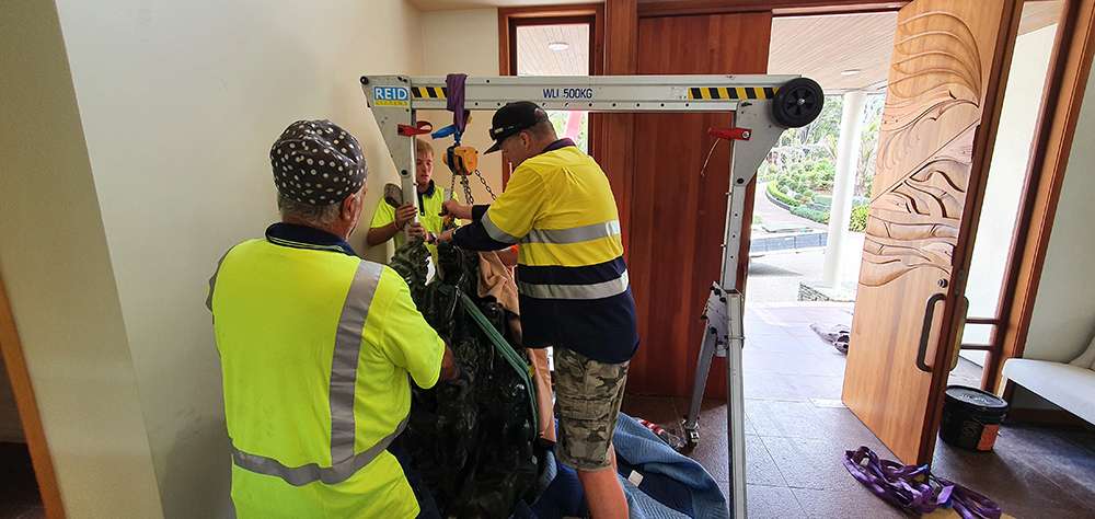 Hiab crane lifting heavy object indoors. Safe lifting practices on construction site. HIAB lifting equipment for construction.
