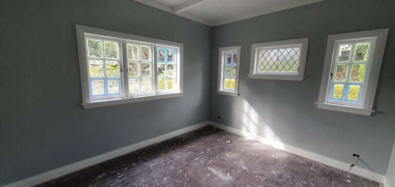 Interior wall insulation project: Empty room with three windows before insulation. Case study on interior wall insulation.