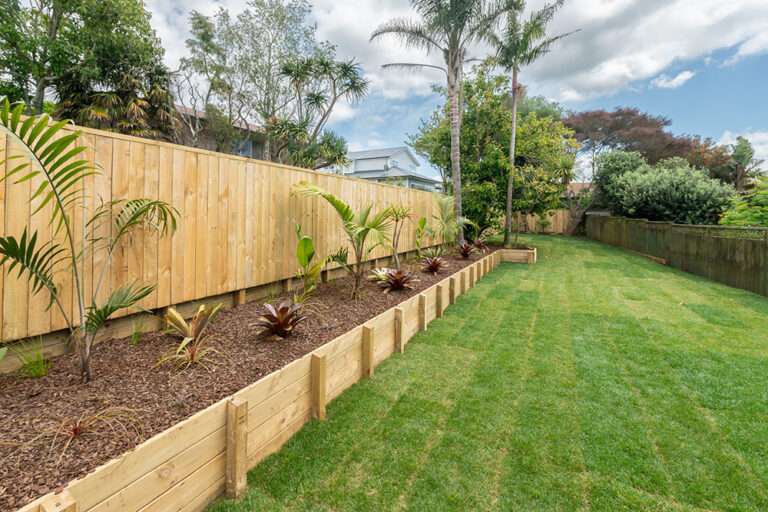 Market Ready past project: Beautifully landscaped backyard with new wooden fence, planter boxes, and lush green lawn.