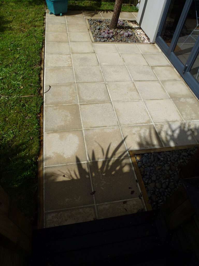 Paving Clean-up: Cleaned paving stones create a tidy outdoor patio and garden area. Stone surface cleaning, paving maintenance.