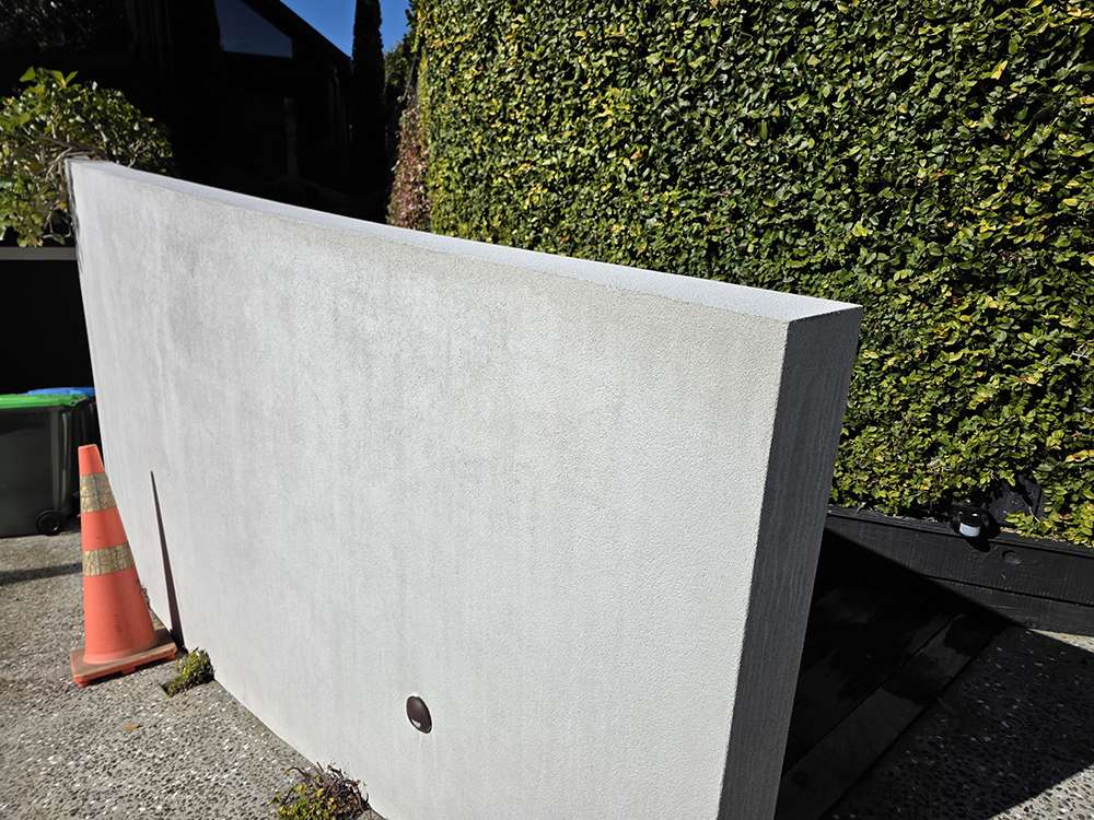 Exterior concrete resurfacing case study: Smooth, newly resurfaced concrete wall with clean lines and modern aesthetic.