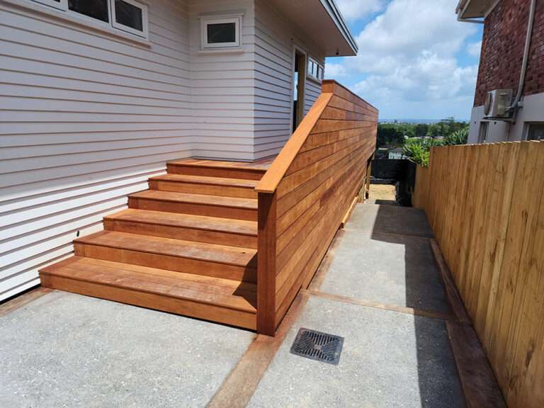 Market Ready past project: Wooden steps with a handrail lead to a home's entrance. Exterior design and construction.