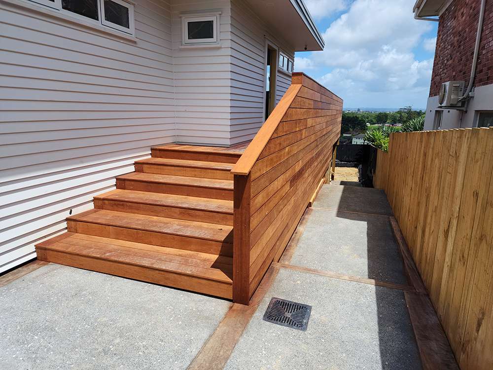 Market Ready past project: Wooden steps with a handrail lead to a home's entrance. Exterior design and construction.