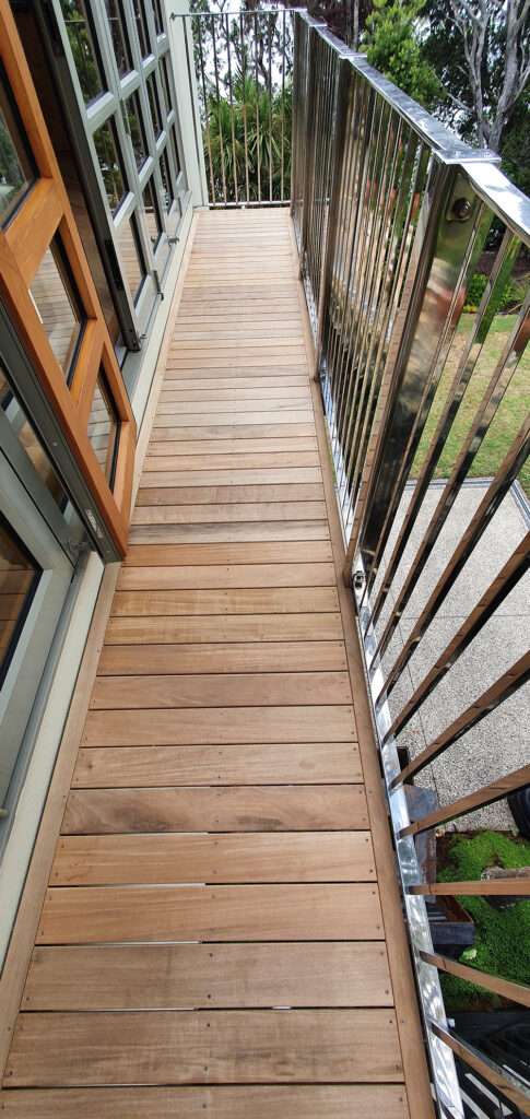 Repaired Kwila decking with stainless steel railing, enhancing outdoor space. Professional decking repair for lasting beauty.