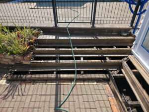 Rotten timber decking repair project. Damaged wood deck with missing planks needing replacement and renovation by Market Ready.