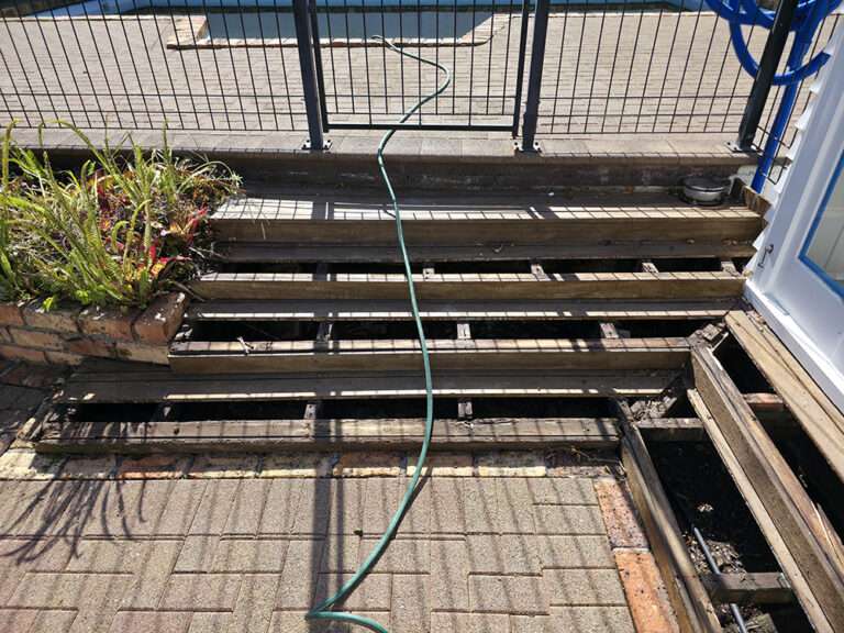 Rotten timber decking repair project. Damaged wood deck with missing planks needing replacement and renovation by Market Ready.