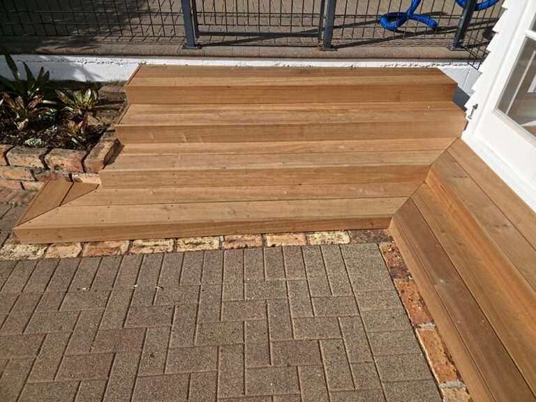 Market Ready past project: new timber steps leading to a deck. Features brick edging and a herringbone brick path.