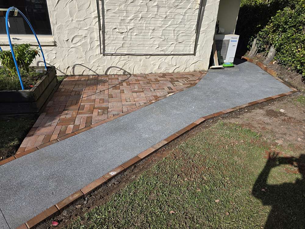 Brick releveling case study: A revitalized brick patio and walkway showcasing expert brickwork and landscaping.