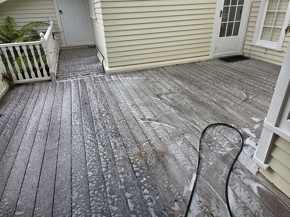 Moss and mould treatment on wooden deck. Shows cleaning process, part of moss mould removal case study.