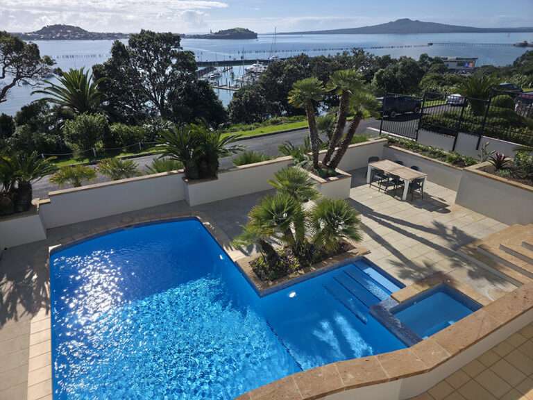 Pool painting project: Beautiful view with refurbished pool, new paint, pump repair completed. Outdoor living at its finest.
